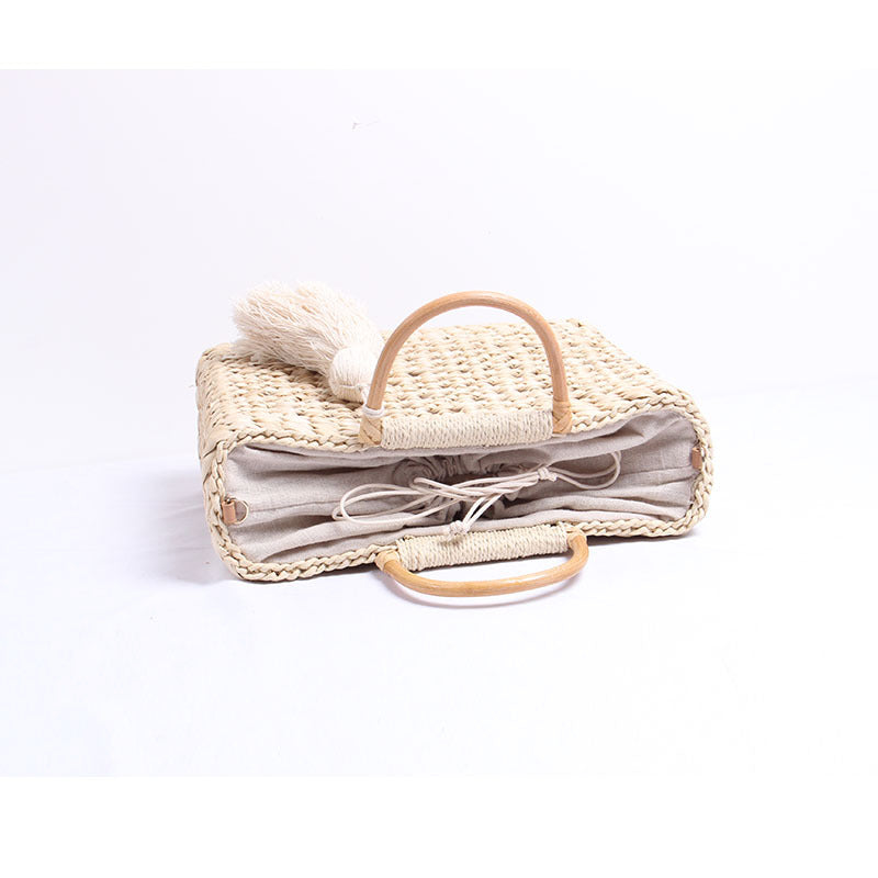 Handcrafted straw shoulder bag with decorative tassel pendant LoungeYard — product view 4
