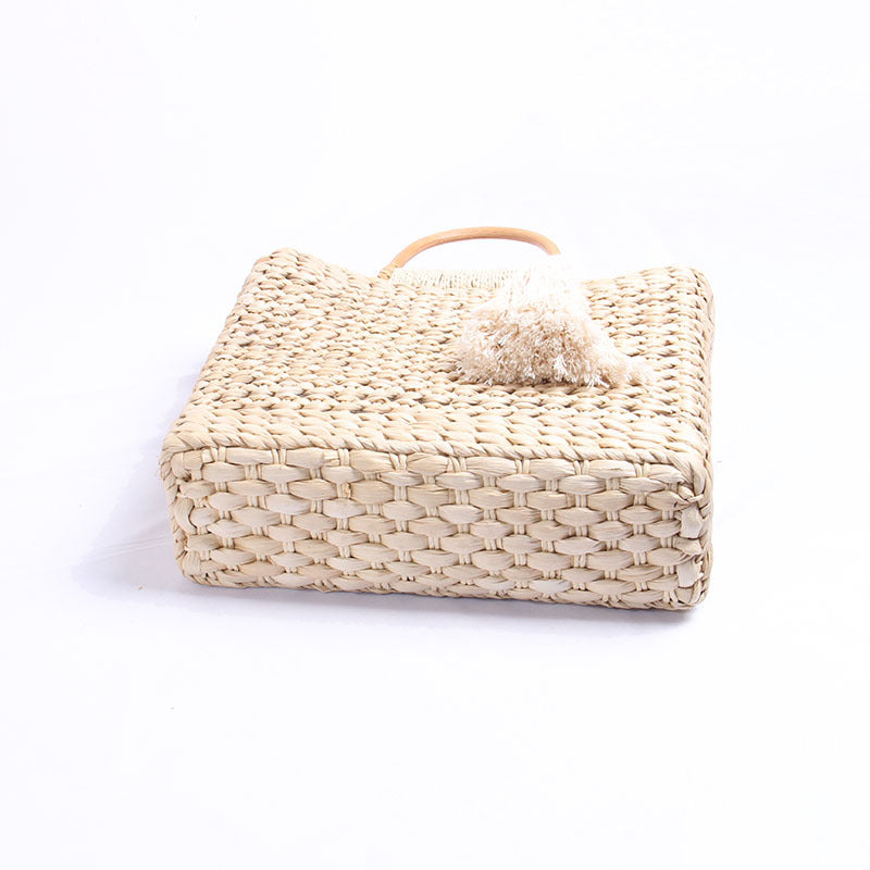 Handcrafted straw shoulder bag with decorative tassel pendant LoungeYard — product view 3
