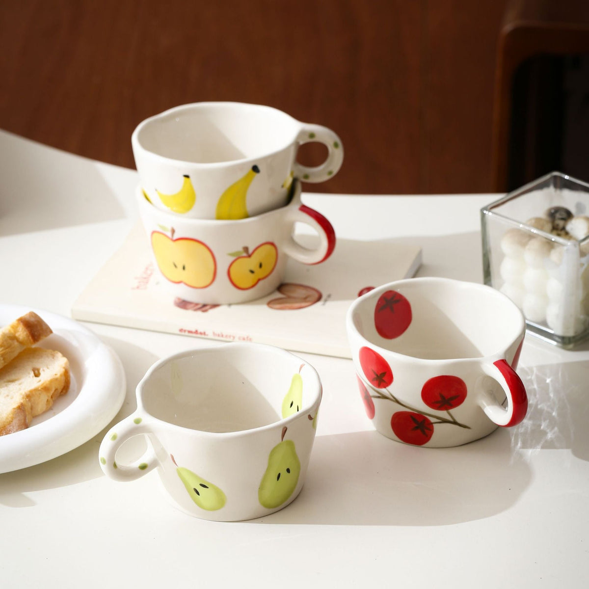 Ceramic mug with hand-painted banana illustration and round handle — product view 1
