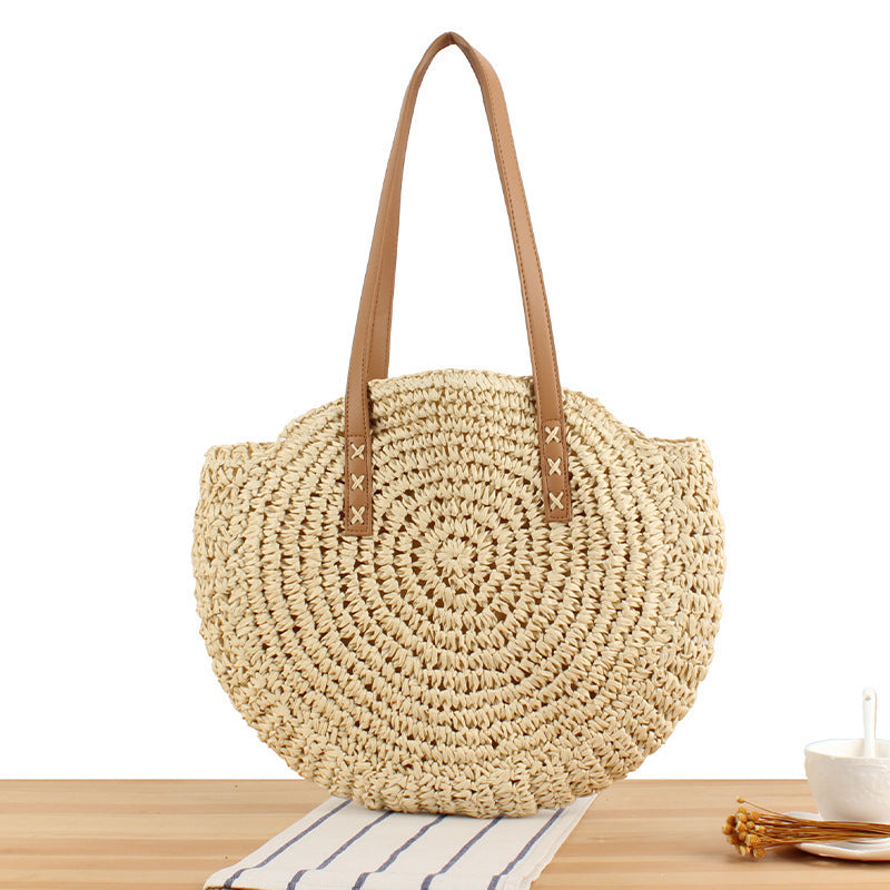 Round straw bag with leather handles LoungeYard — product view 1