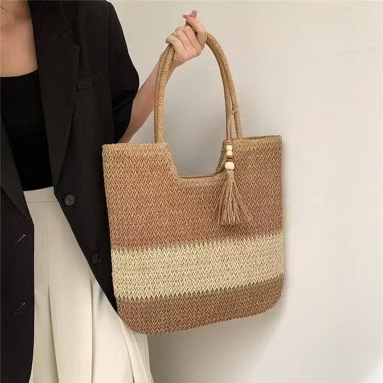Handbag made of braided natural material with tassel details LoungeYard — product view 1