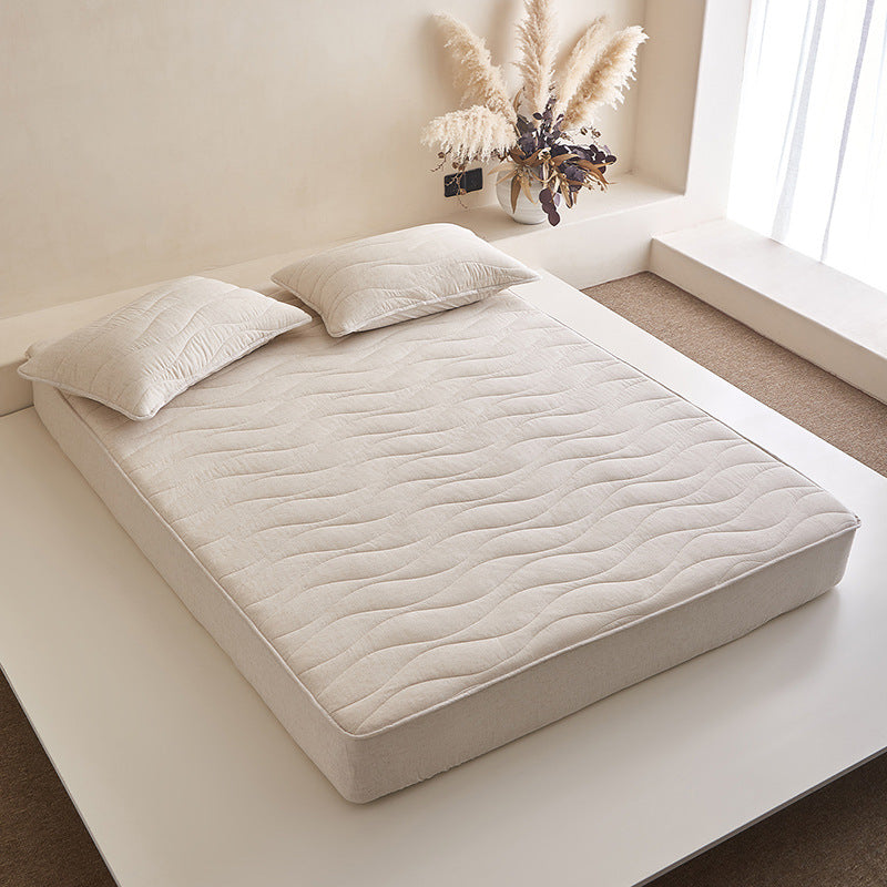 Quilted mattress topper with all-around fitted edge and breathable padding — product view 1