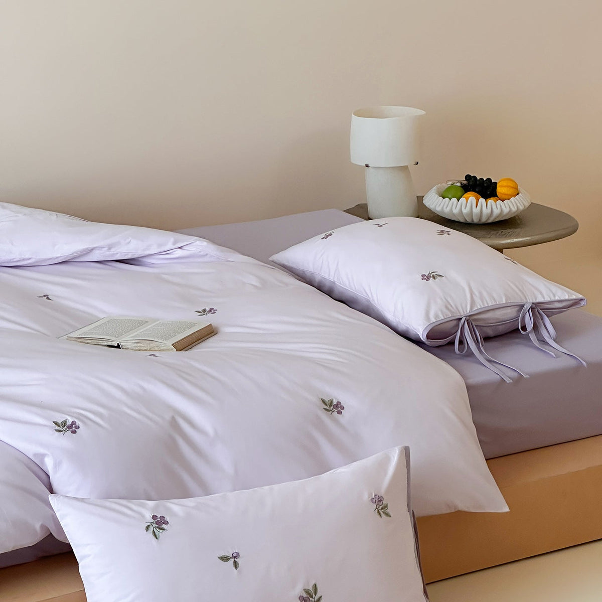 Reversible cotton bedding set with fine check pattern, cherry embroidery, and decorative tie ribbons — product view 1