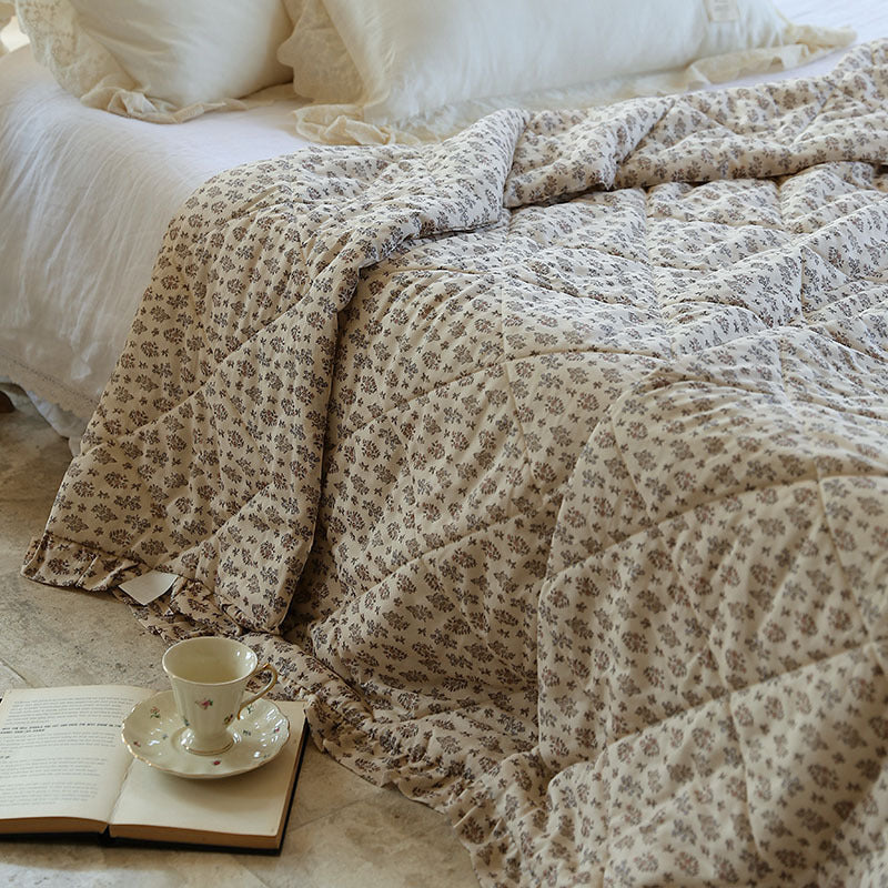 Lightly quilted throw blanket in vintage floral print with ruffled edge — product view 1