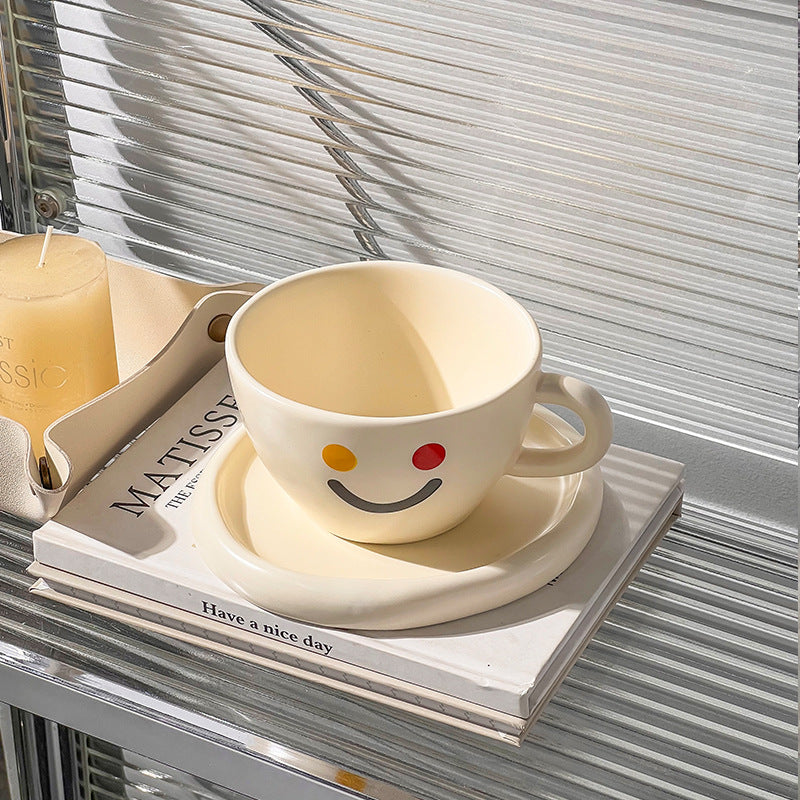Handcrafted ceramic mug and plate set with cheerful smiley relief and organic shape — product view 2