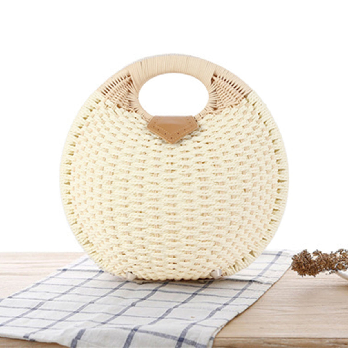 Round straw bag with elegant leather handle LoungeYard — product view 1
