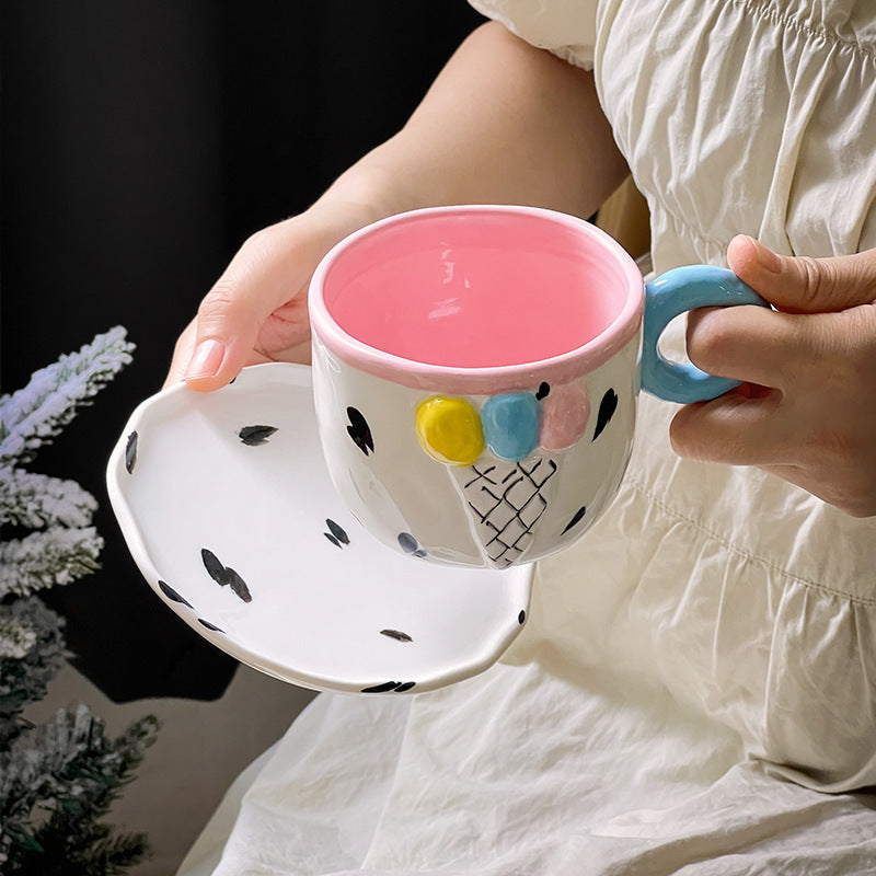 Playful handcrafted ceramic cup composition with saucer and pastel-colored round handle — product view 2