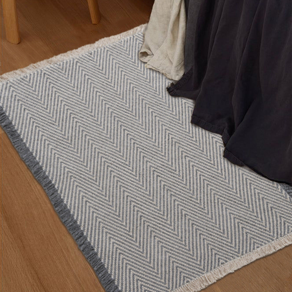 Handwoven cotton bath mat with herringbone pattern and fringes LoungeYard — product view 2