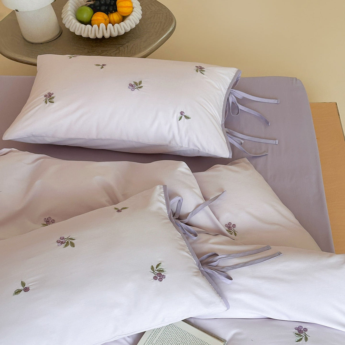 Reversible cotton bedding set with fine check pattern, cherry embroidery, and decorative tie ribbons — product view 3