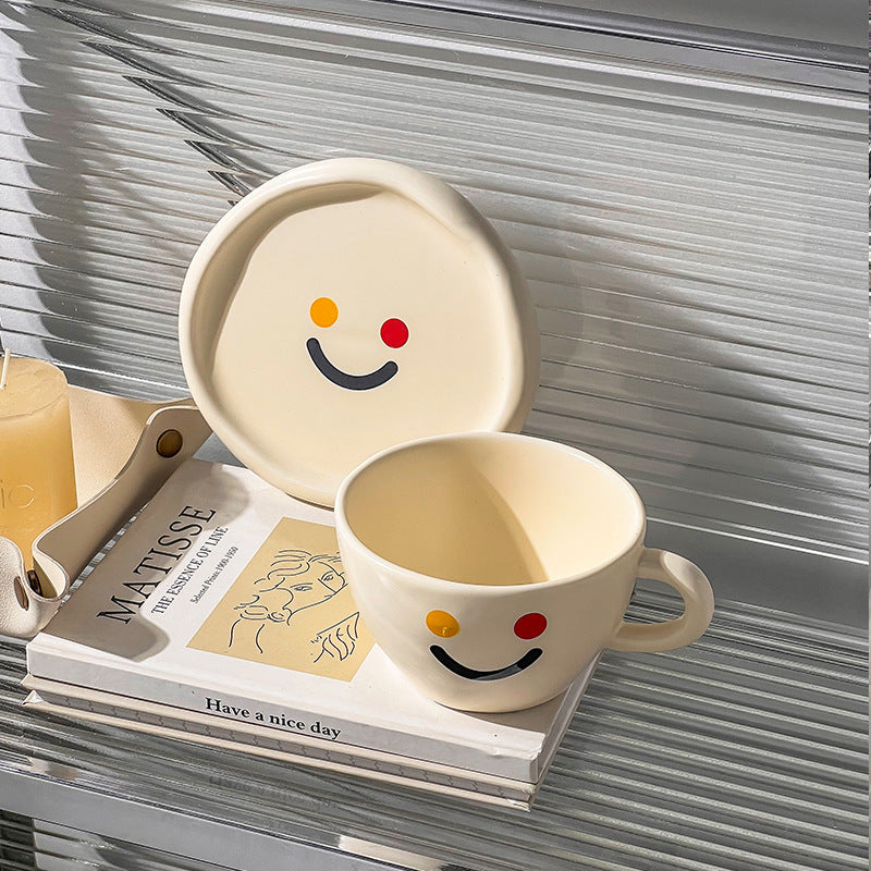 Handcrafted ceramic mug and plate set with cheerful smiley relief and organic shape — product view 3
