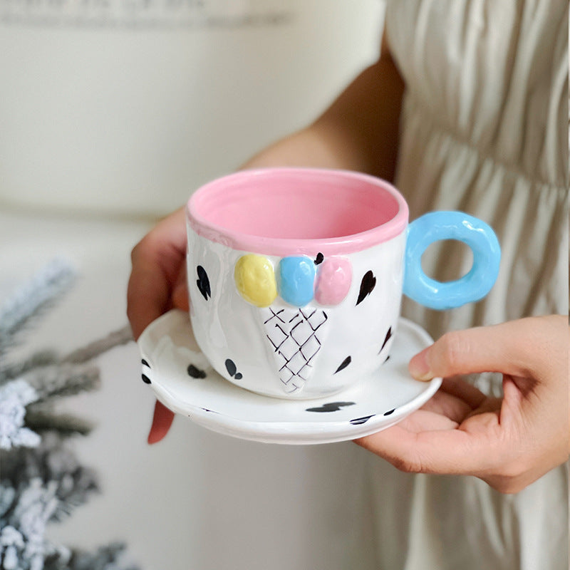 Playful handcrafted ceramic cup composition with saucer and pastel-colored round handle — product view 3