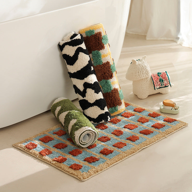 Hand-tufted bathroom bath mat with non-slip backing and textured square relief LoungeYard — product view 1