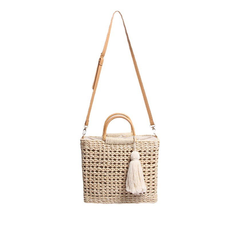 Handcrafted straw shoulder bag with decorative tassel pendant LoungeYard — product view 5