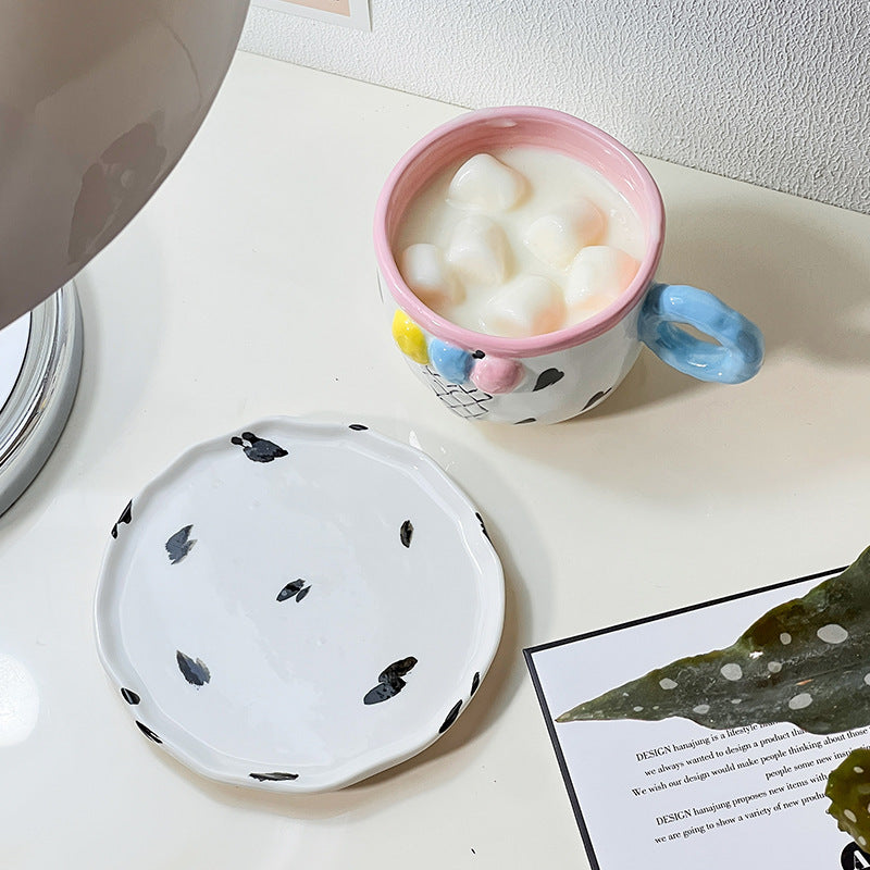 Playful handcrafted ceramic cup composition with saucer and pastel-colored round handle — product view 4