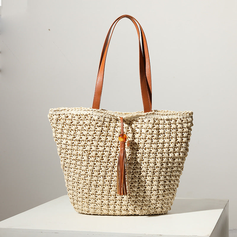 Handcrafted basket bag with fashionable tassel detail LoungeYard — product view 1