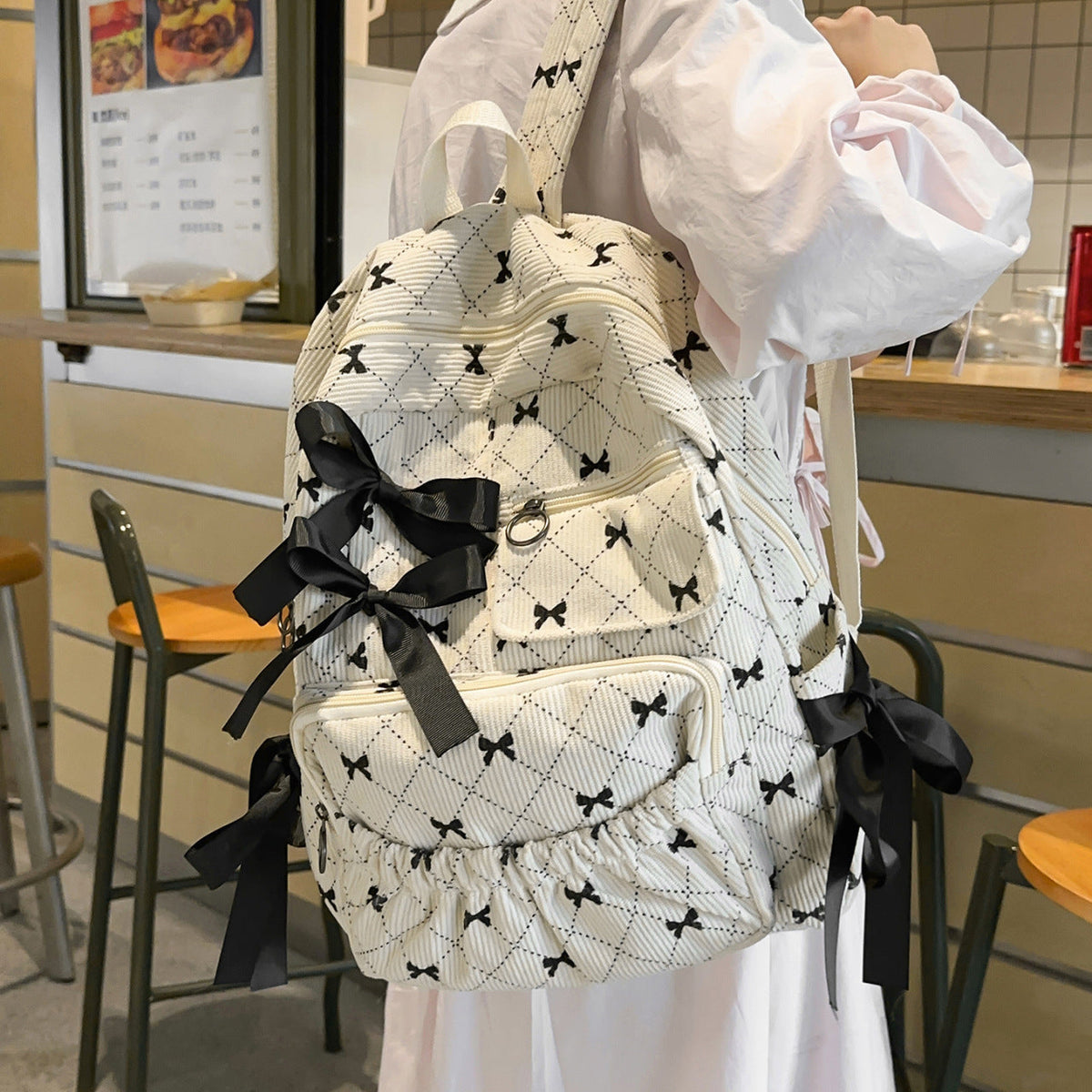 Playful backpack with bow details and practical compartments LoungeYard — product view 2